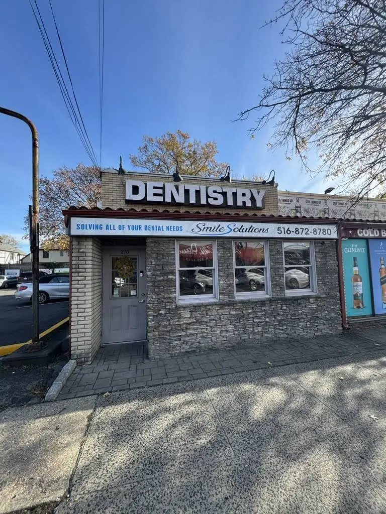 Smile Solutions - Professional dental clinic exterior with modern facilities